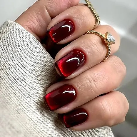 Elevate your bridal look with Dark Red Cat Eye Nails. Perfect for at-home nail care, these stunning nails are on-trend for your wedding day.